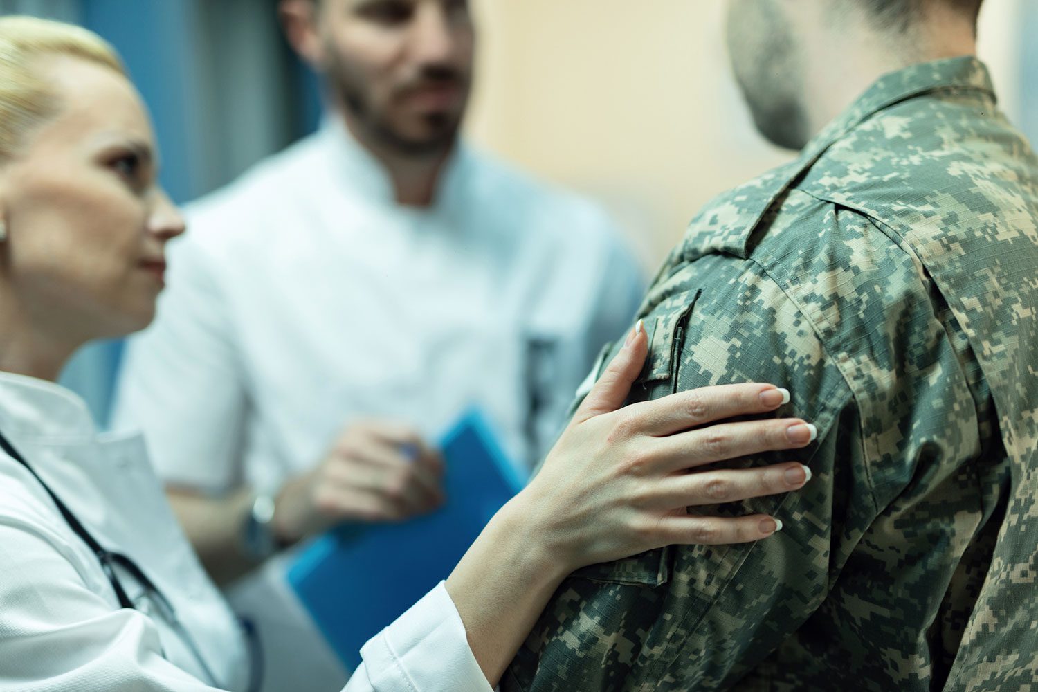 Featured image for PACT Act, showing a female doctor consoling a Veteran