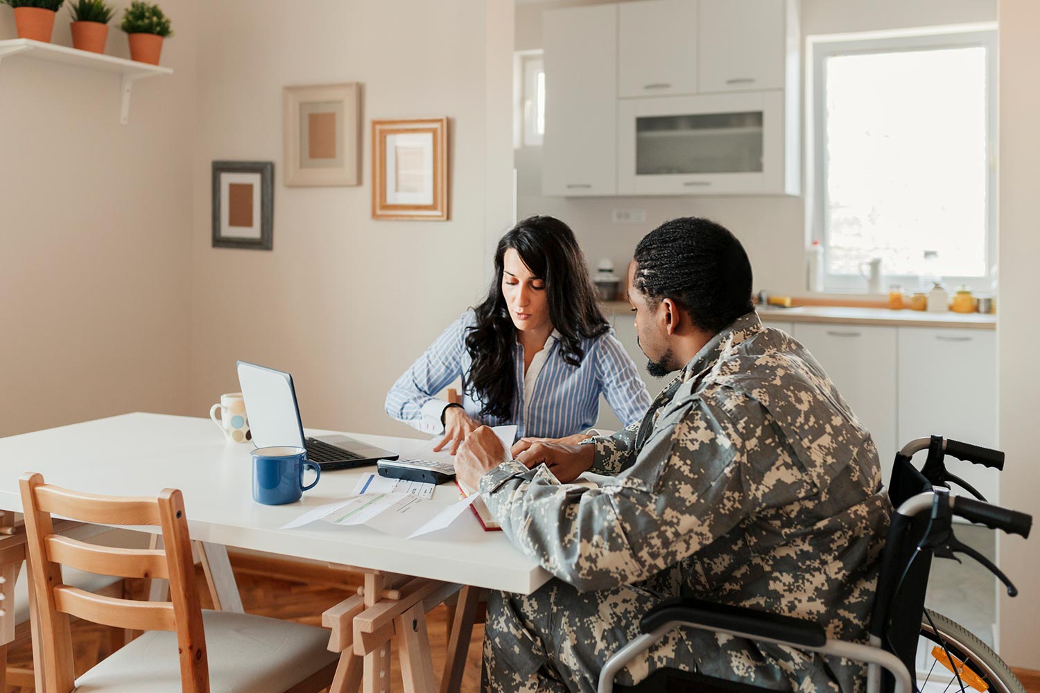 Featured image for Debt Help for Veterans, showing a disabled Veteran with a female financial advisor