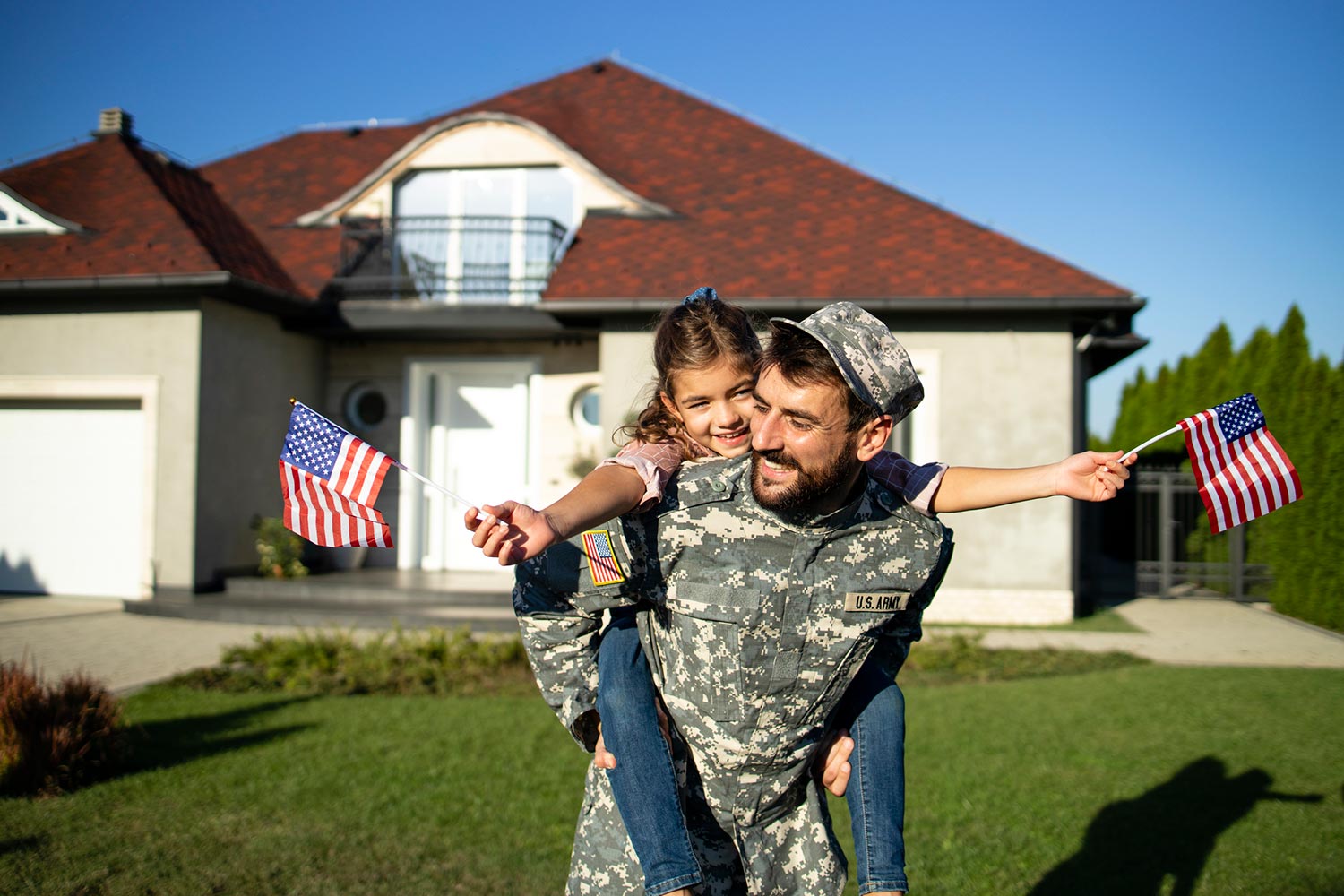 Featured image for VA Cash Out Refinance, showing a happy soldier with his daughter in front of their home
